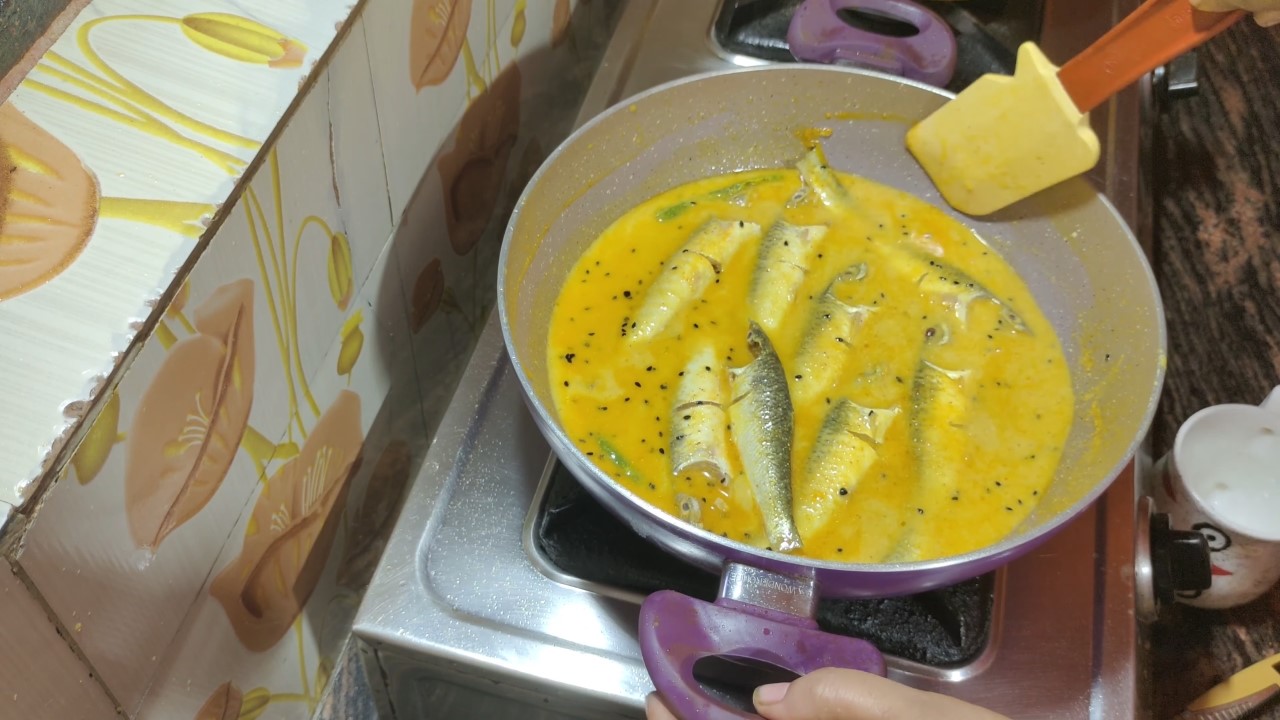 Adding the fish to the cooking pan