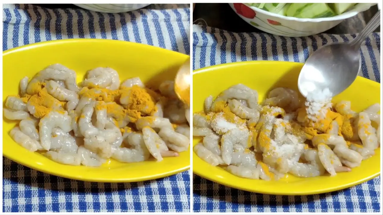 Marinating prawns with salt and turmeric powder