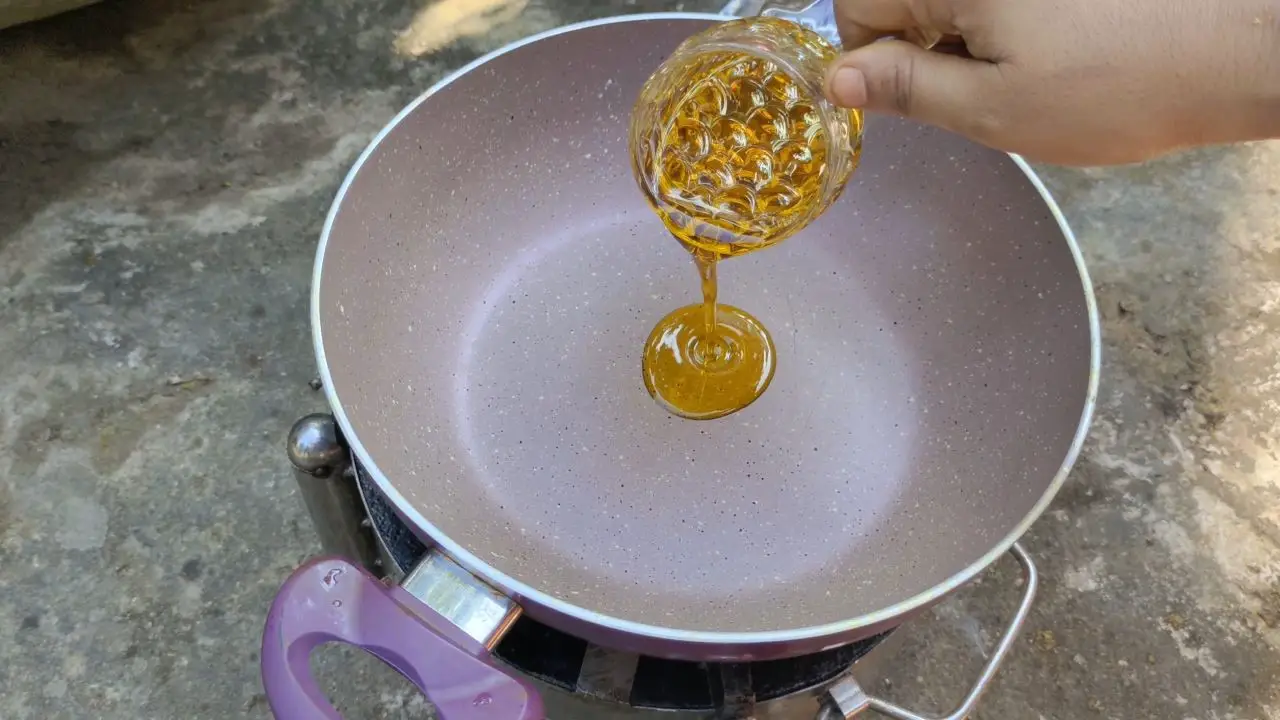 Adding oil in Kadai