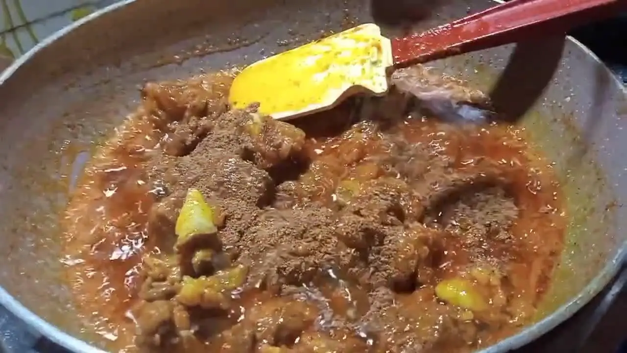 Adding roasted spices to the mutton