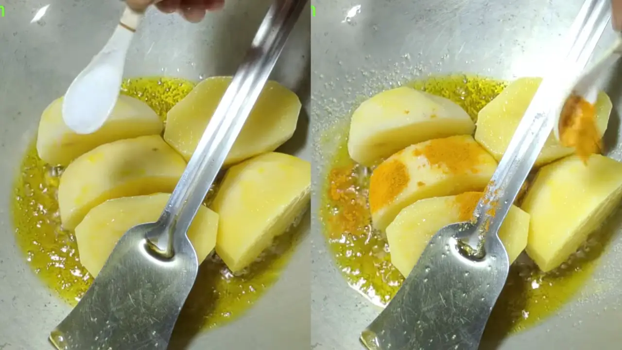 Adding salt and turmeric powder to potatoes while frying