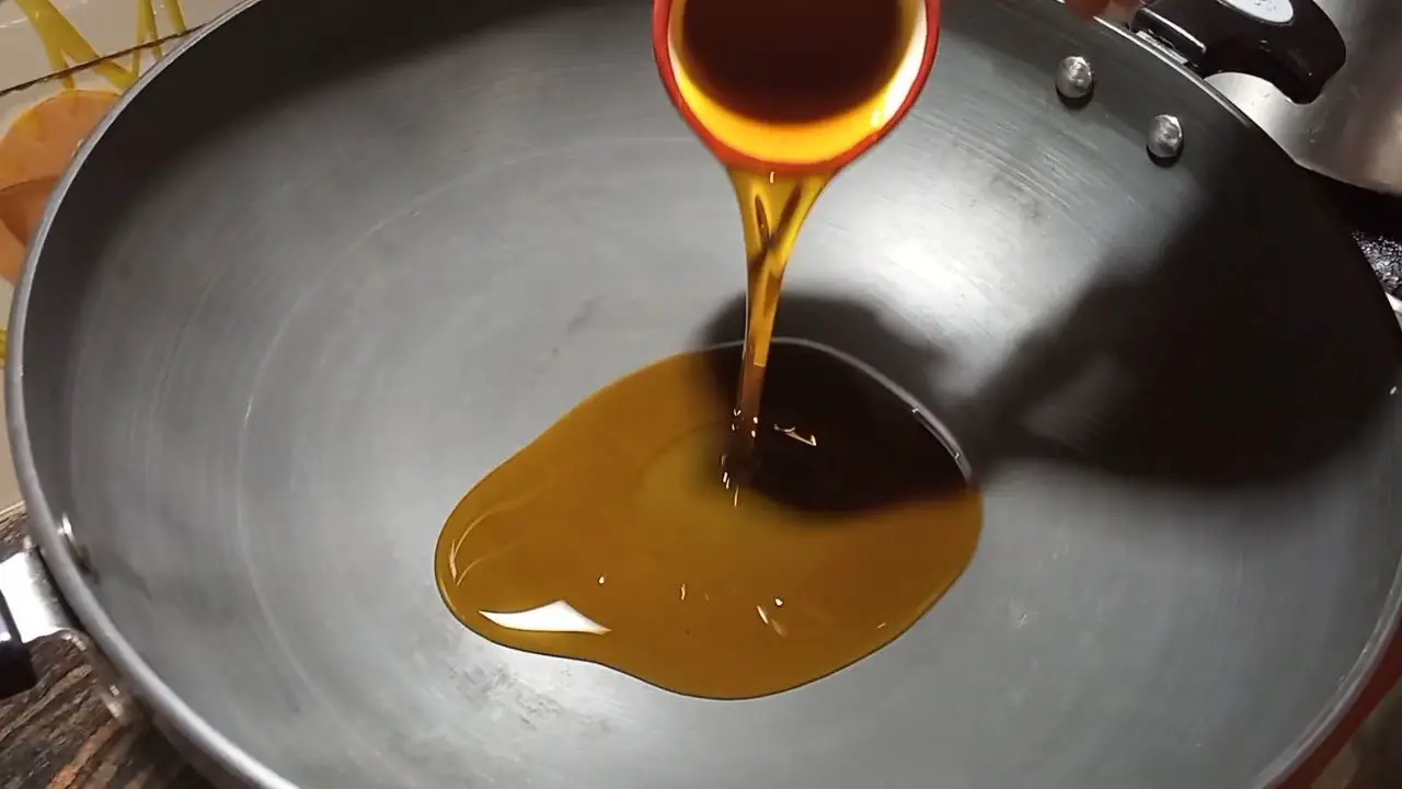 Pouring oil into the cooking pan