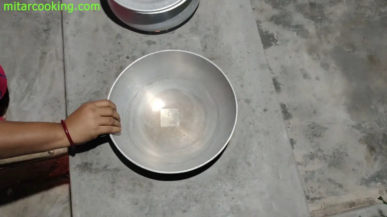 Placing a kadai on the clay stove