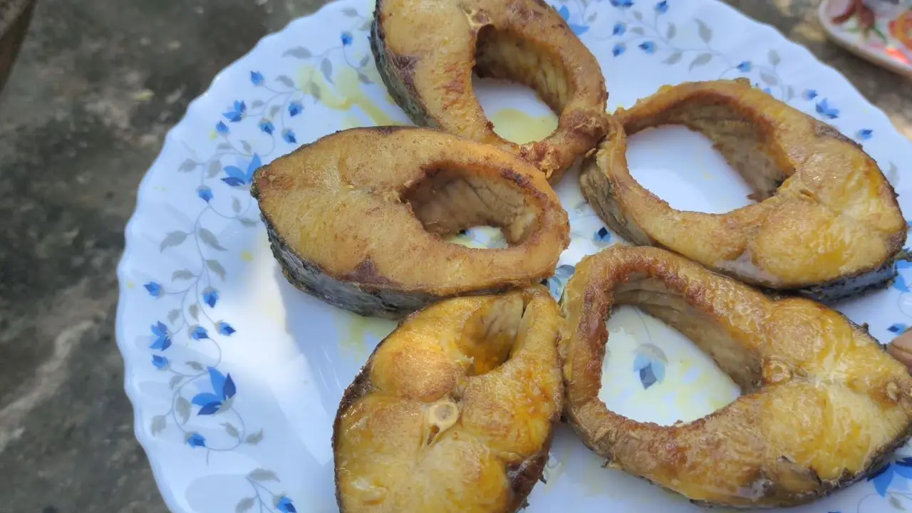 Taking out fried fish pieces