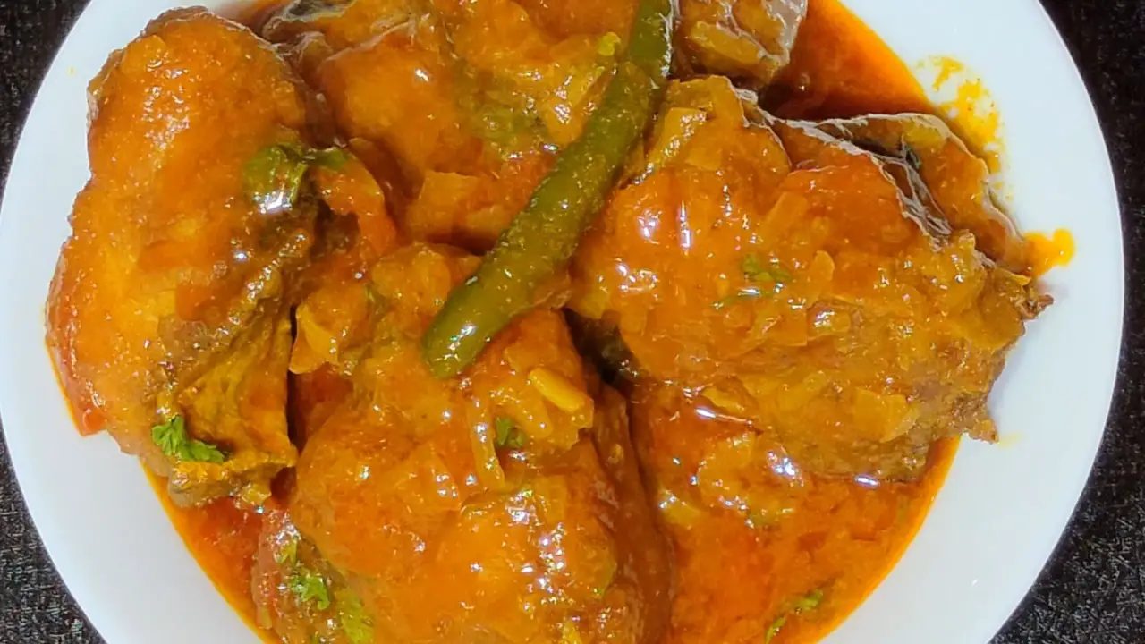 Transferring the Bengali fish curry to a bowl