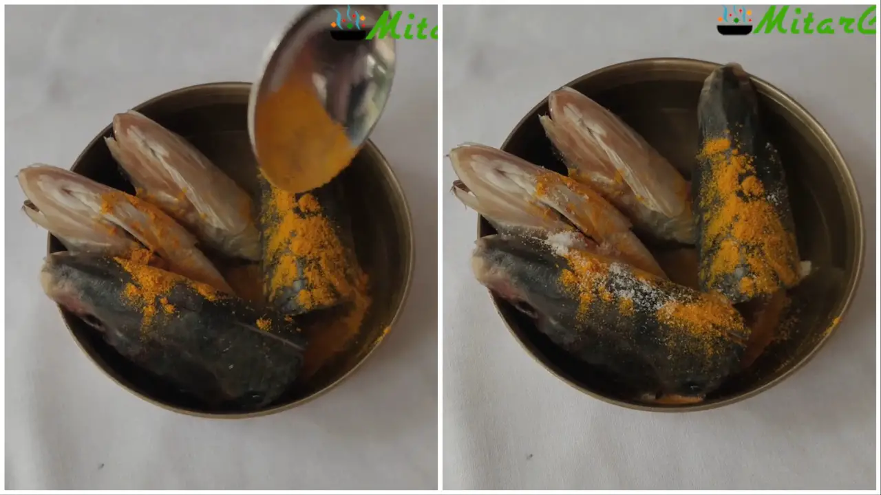 Marinating the hilsa heads with salt and turmeric powder