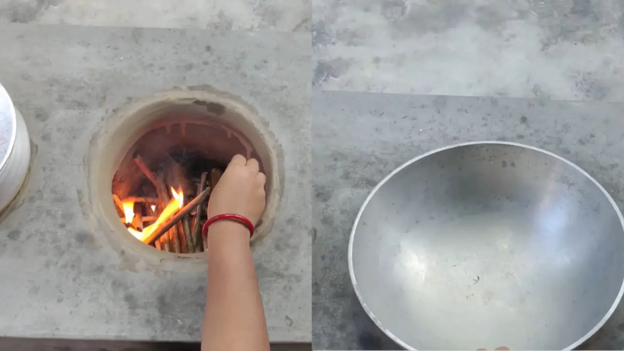 Heating the kadai on clay stove