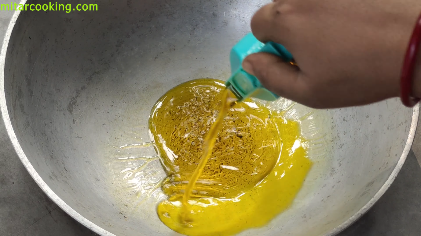 Pouring mustard oil into the wok