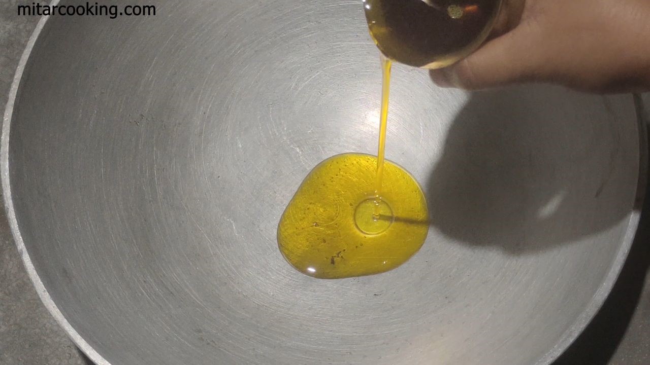 Adding mustard oil into a hot kadai