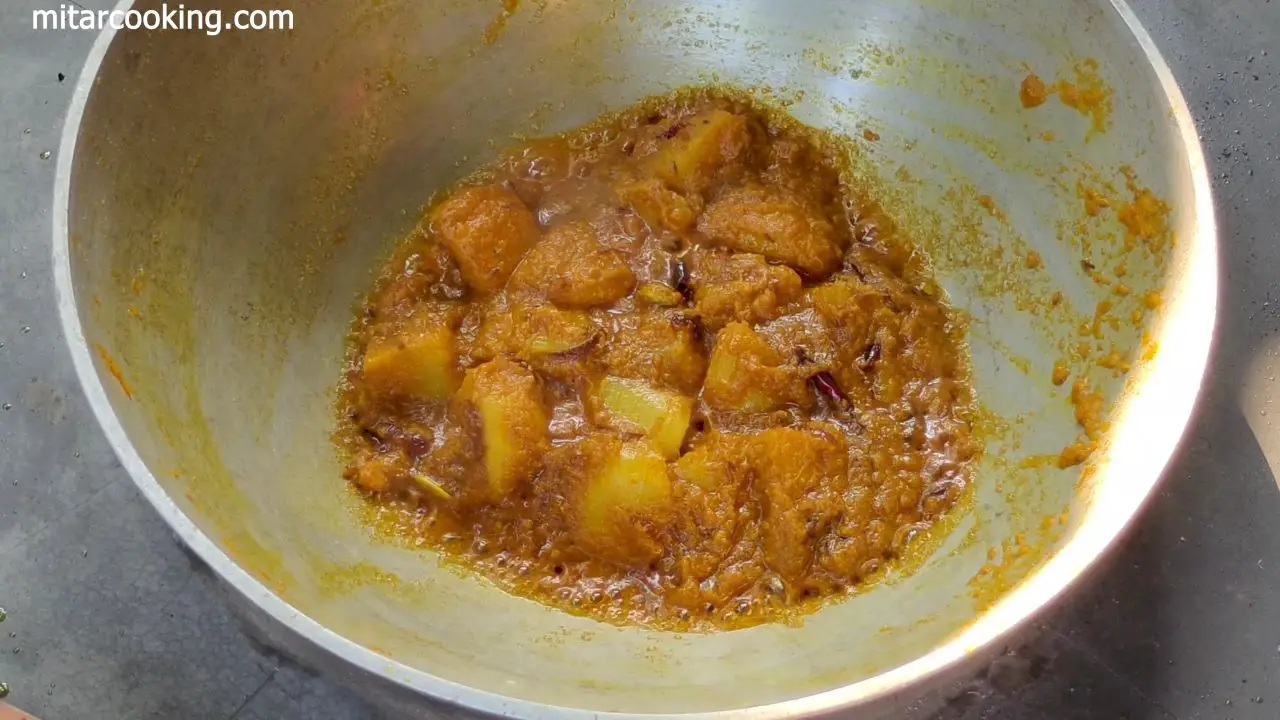 Adding fried potato cubes