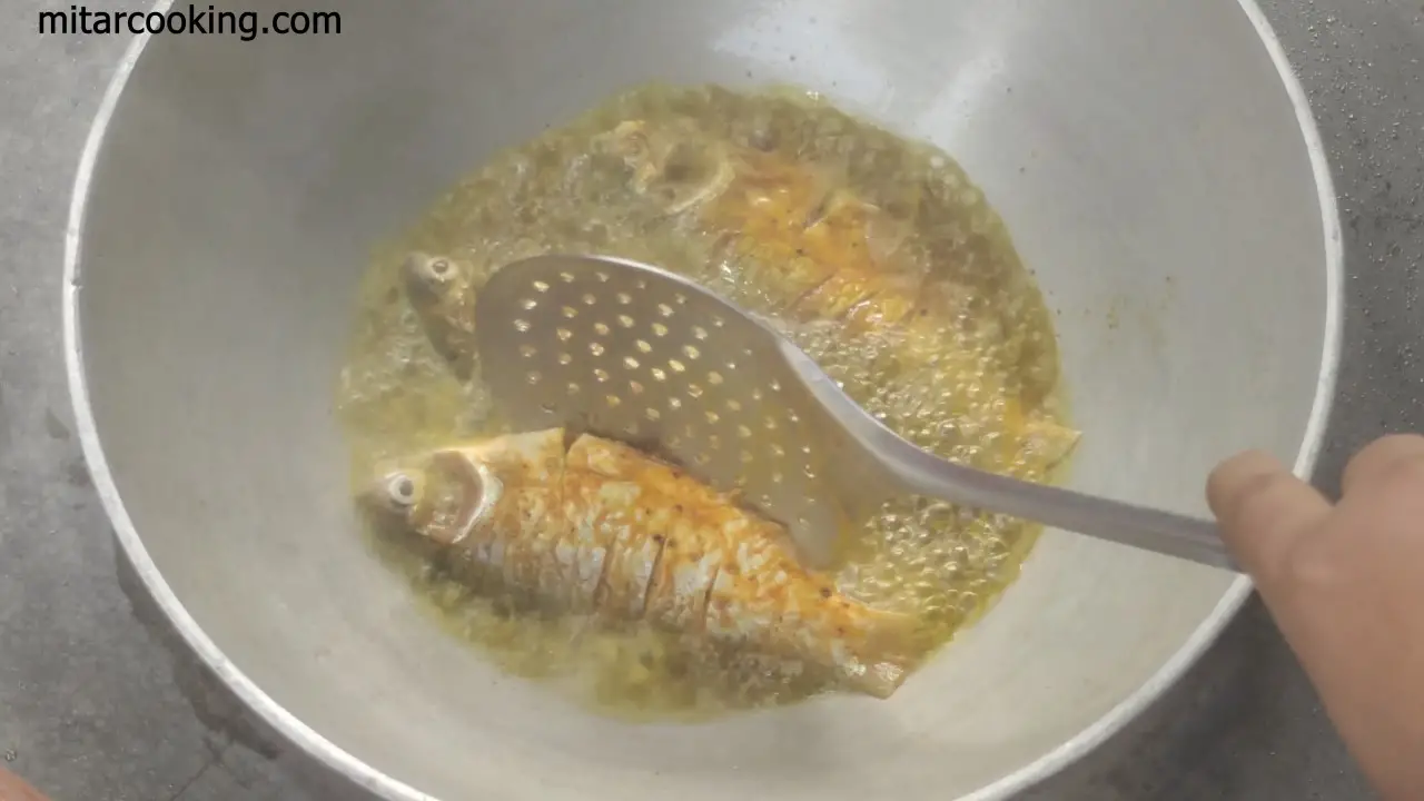Adding puti fishes one by one to the hot oil