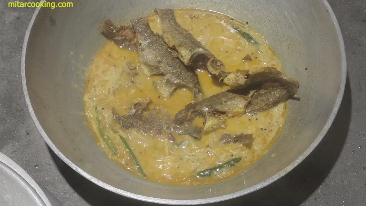 sliding the tilapia fish one by one into the wok