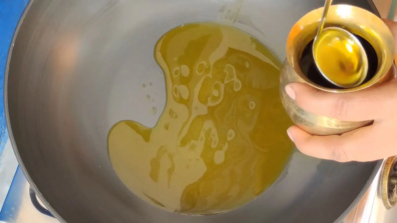 Add 4 tablespoons of mustard oil in the kadai (wok)