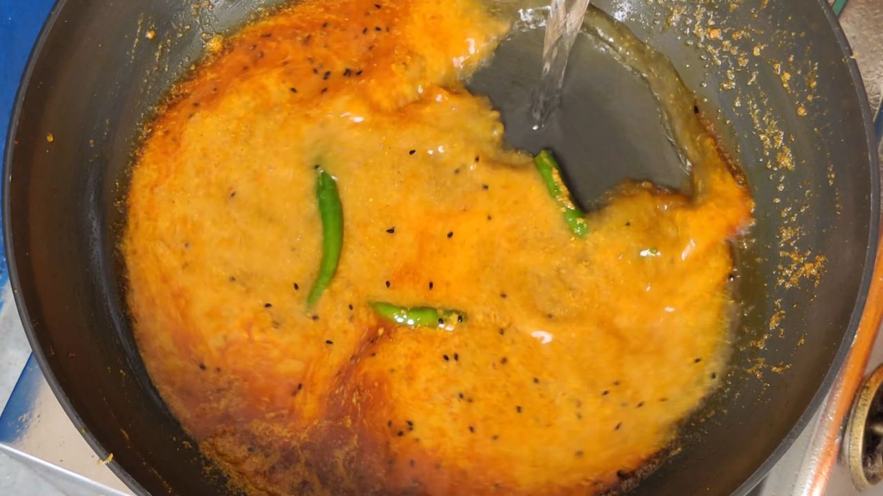 Adding water in the masala paste