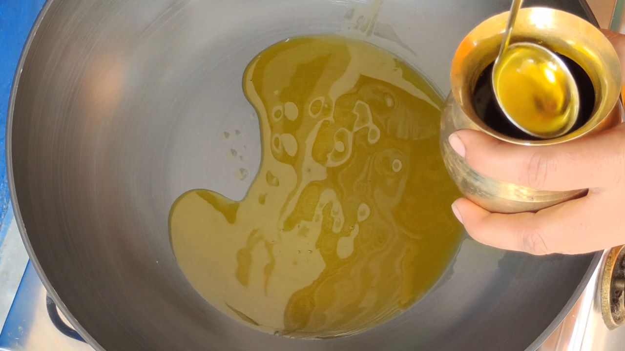 Add 4 tablespoons of mustard oil in the kadai (wok)