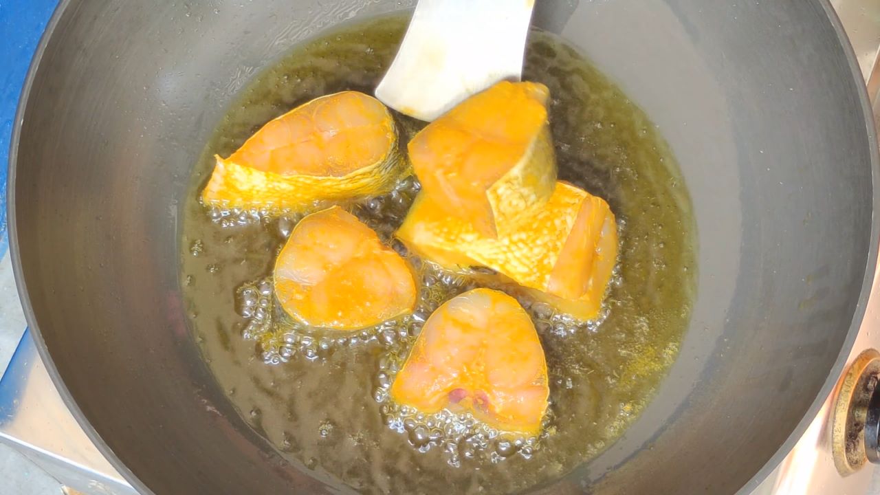 When the oil is hot, slide the fish pieces carefully
