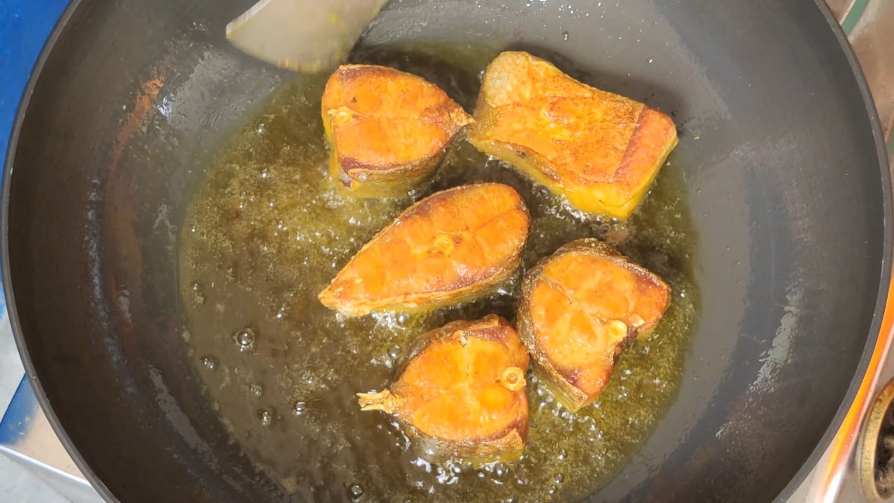 Flip the fish pieces to fry properly