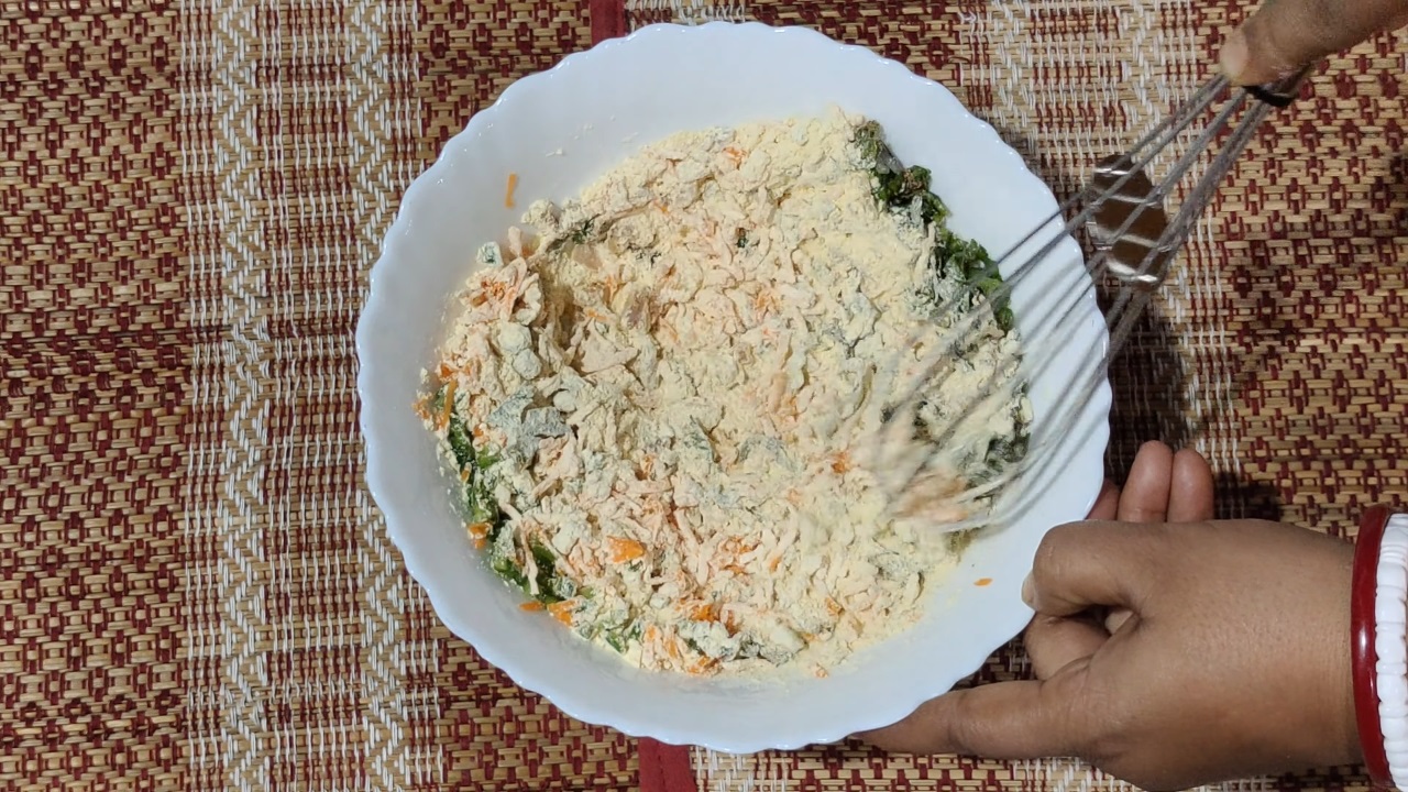 Mixing besan and vegetables well