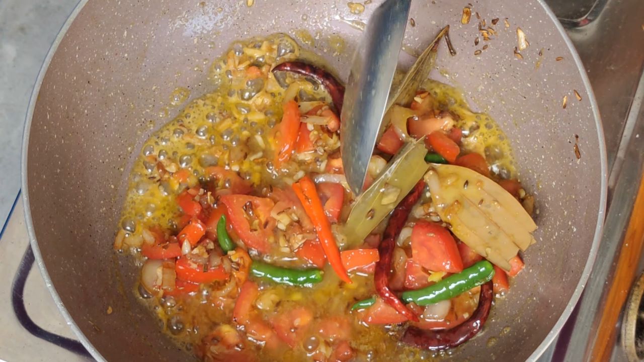 Adding the liquid layer of boiled dal to the tadka