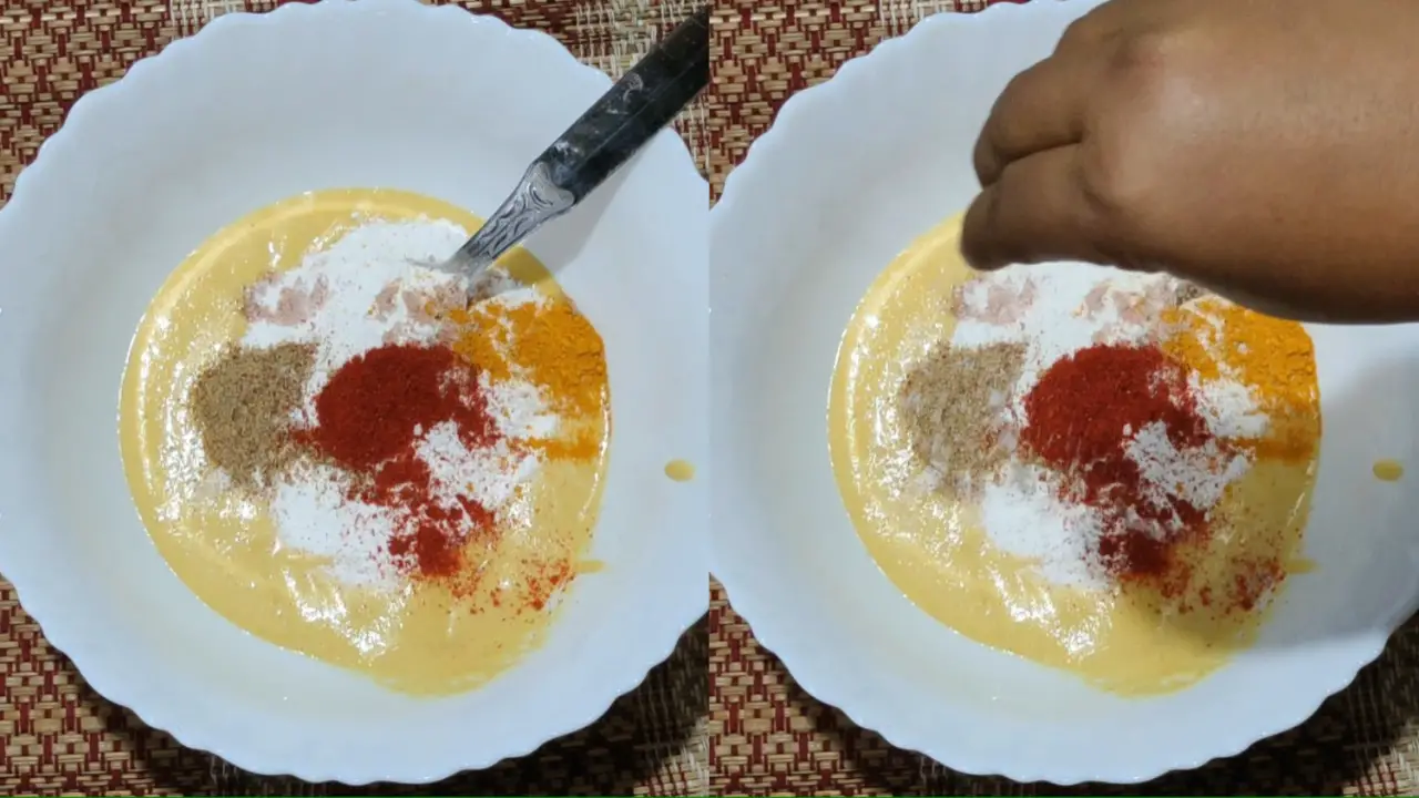 Adding turmeric, red chili powder, and salt to the batter