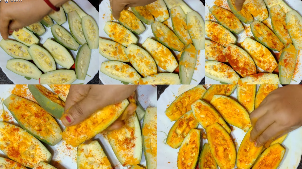 Smearing the pointed gourds, salt, turmeric, and red chili powder