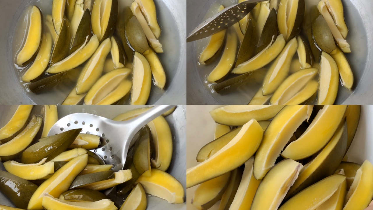 Removing the par-boiled mangoes