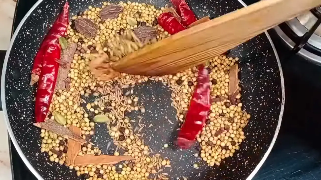 Stirring the ingredients until it is dry roasted