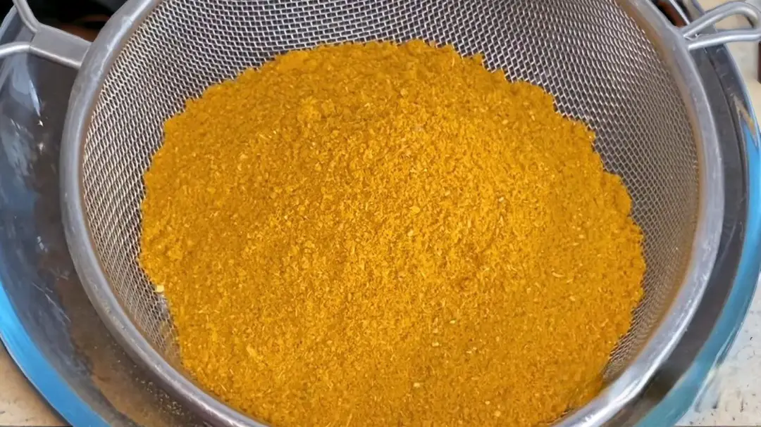 Pouring the mixture into a metal strainer