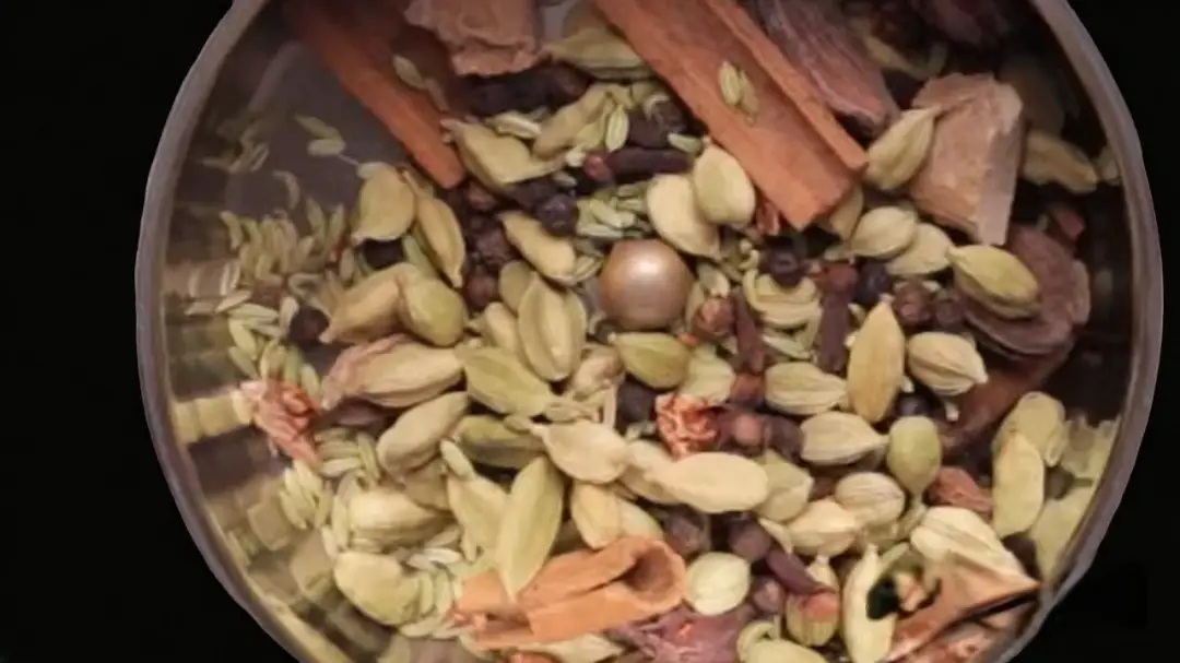 Putting all the roasted and cooled ingredients into a grinder