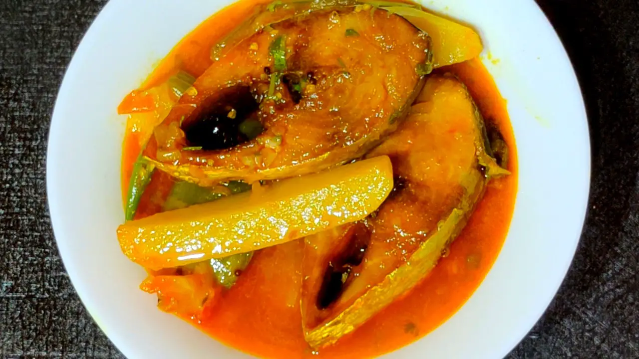 Transferring Ilish macher jhol to a bowl