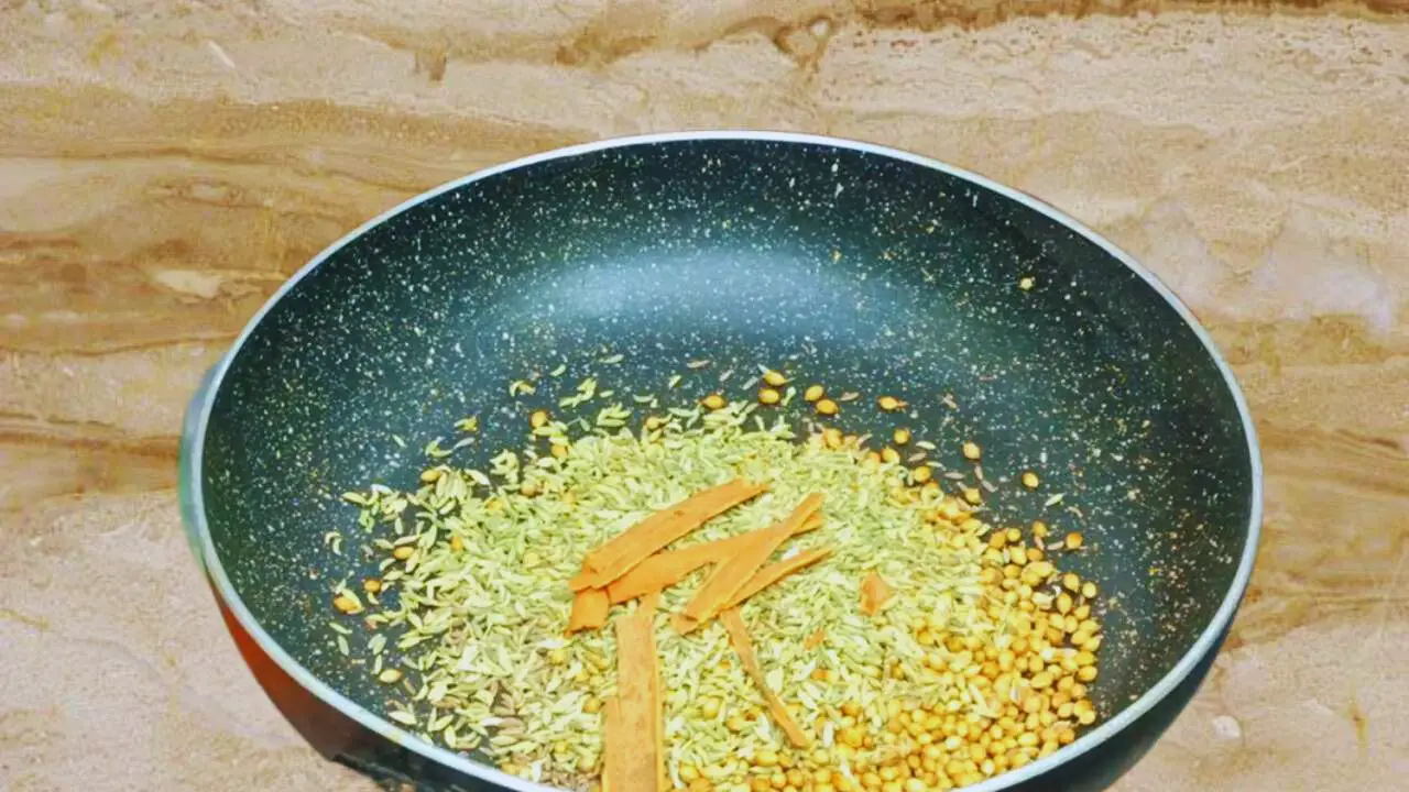 Adding 2 sticks of cinnamon of about 1-inch in size