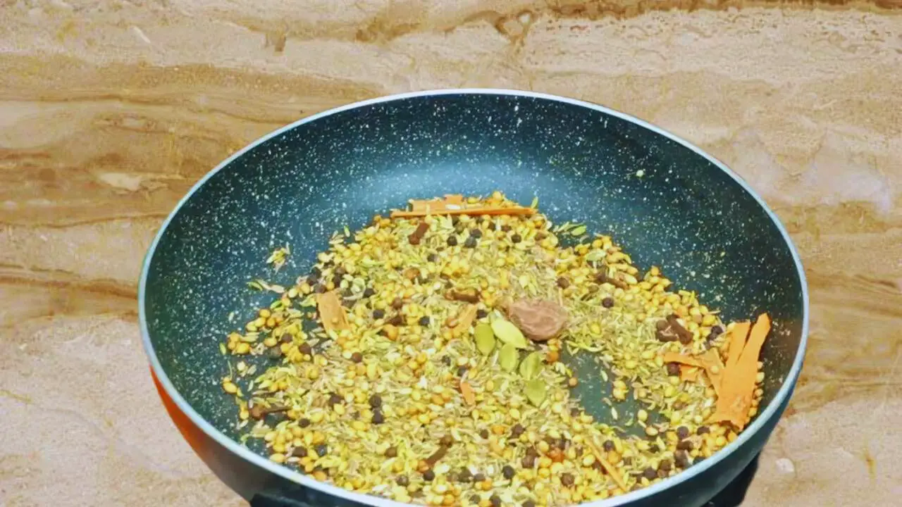 Adding 5 pieces of green cardamom