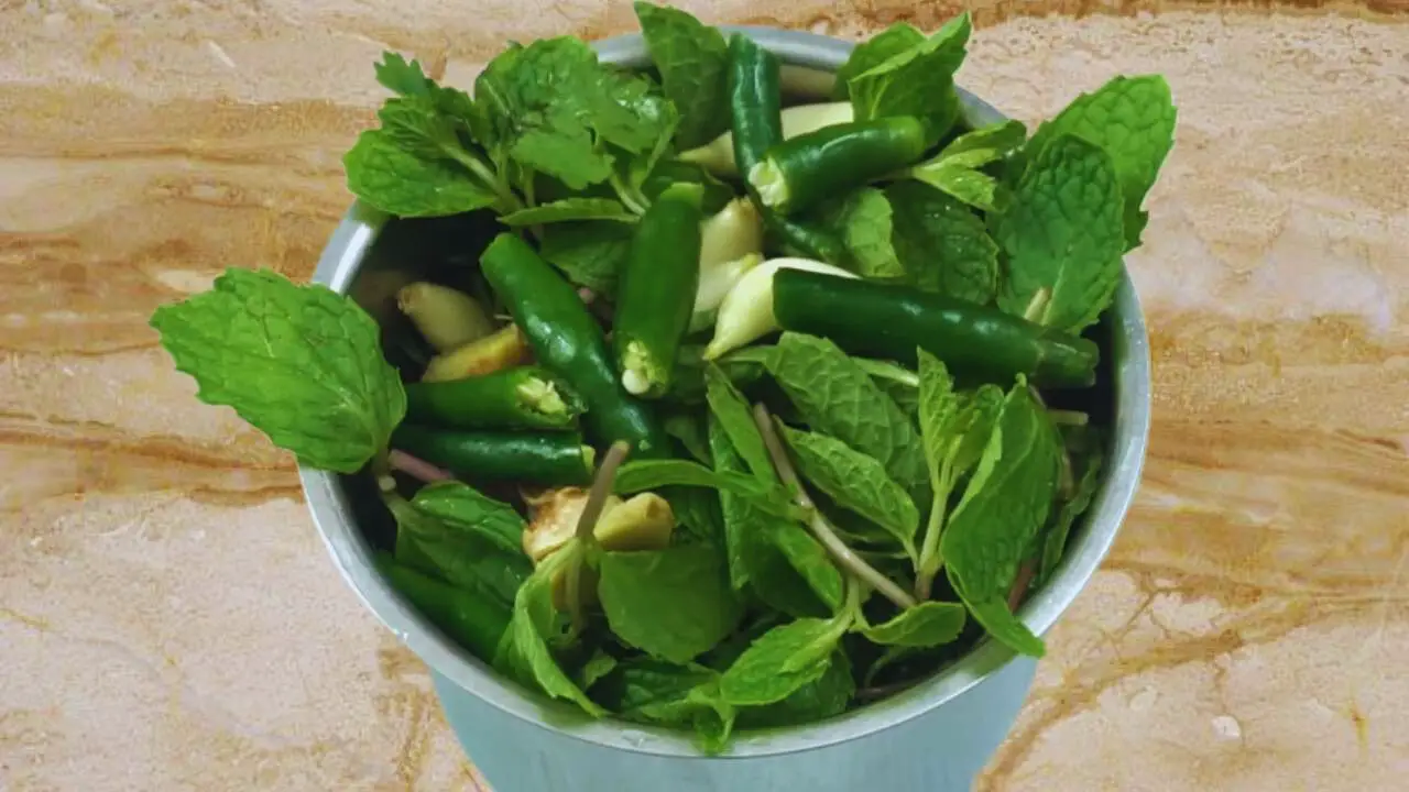 Adding 4 pieces of fresh green chilies