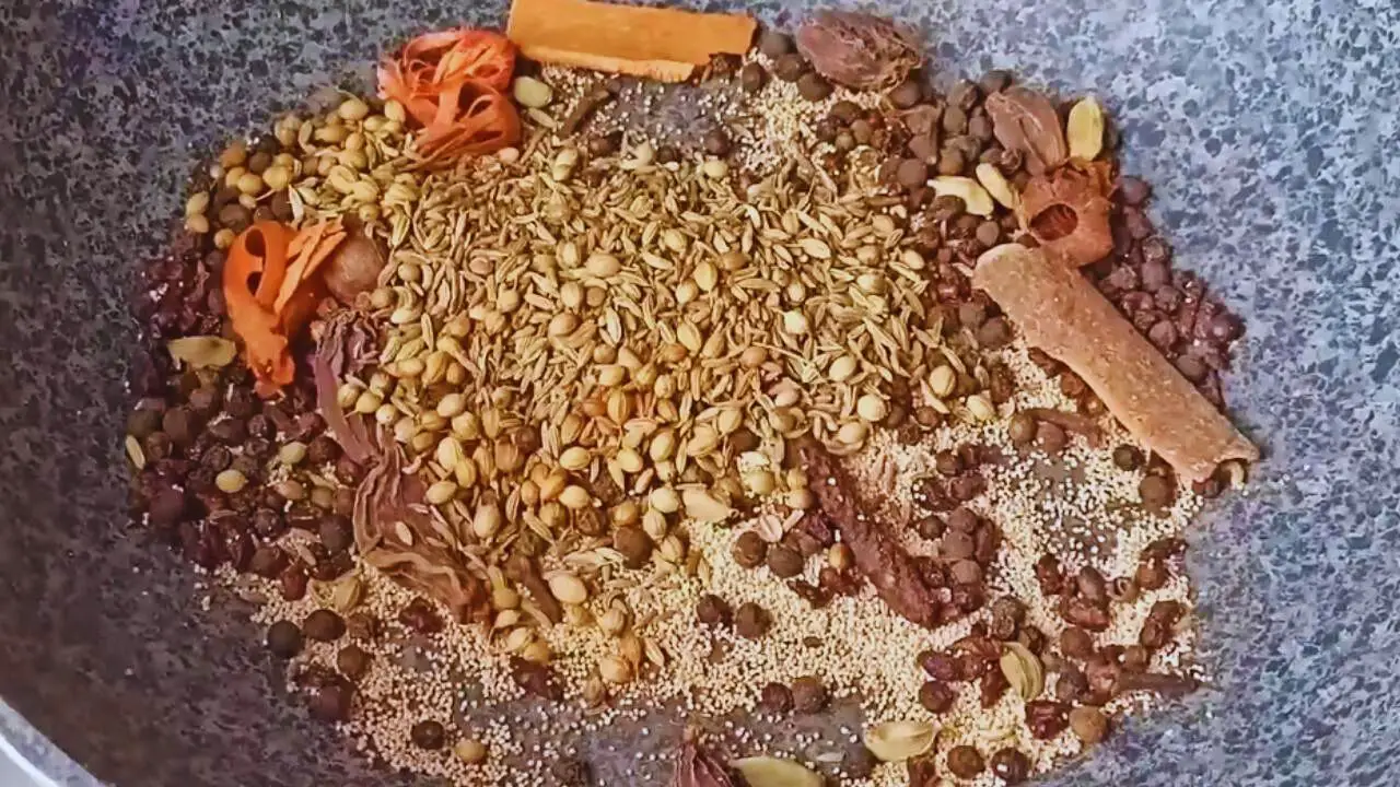 Adding the roasted coriander seeds, cumin seeds, and fennel seeds to it