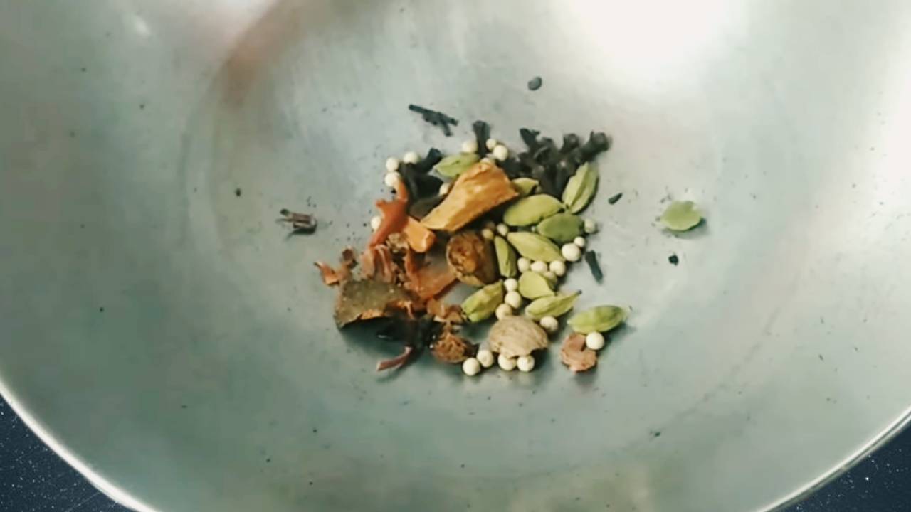 Putting 1 tsp white peppercorns (shah marich), 1 small piece of star anise, 1 small mace (javitri) torn into small pieces, 2 small pieces of nutmeg (jaifal), 2 small sticks of cinnamon, 1 tbsp of green cardamom, and 1 tbsp of cloves into it