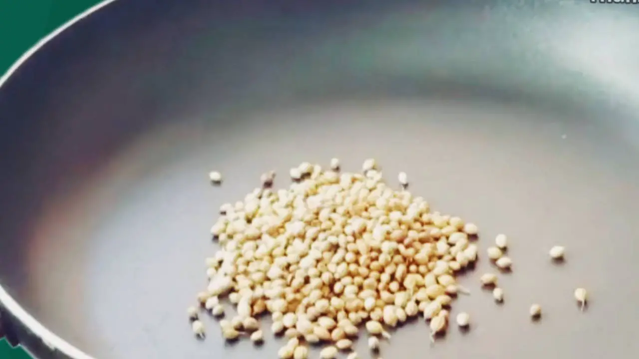 Putting 2 tbsp of coriander seeds in the frying pan