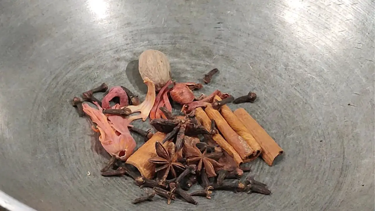 Dry roasting 3 pieces of star anise, two torn pieces of mace, 4 sticks of medium-sized cinnamon sticks, ½ tsp cloves, and one nutmeg