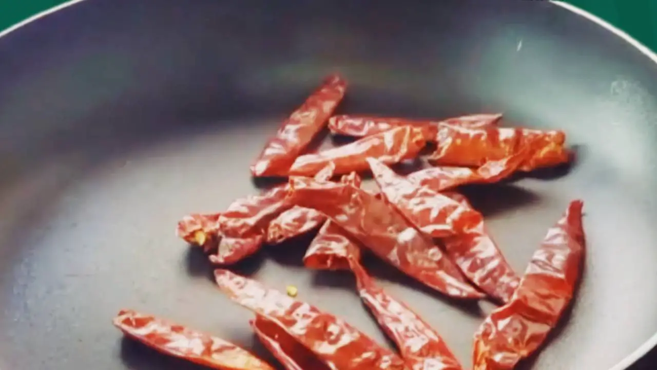 Adding 20 pieces of dry red chilies on pan