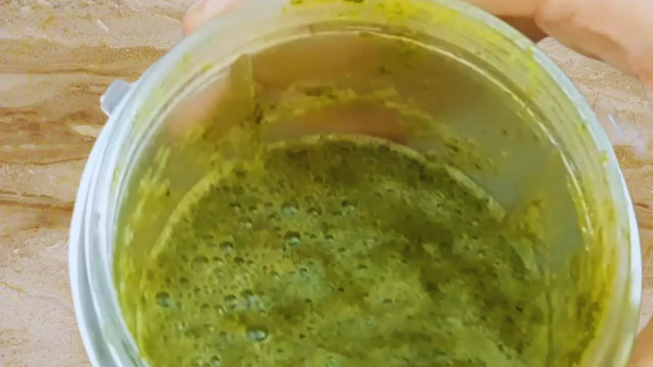 Grinding the leaves to get a fine paste