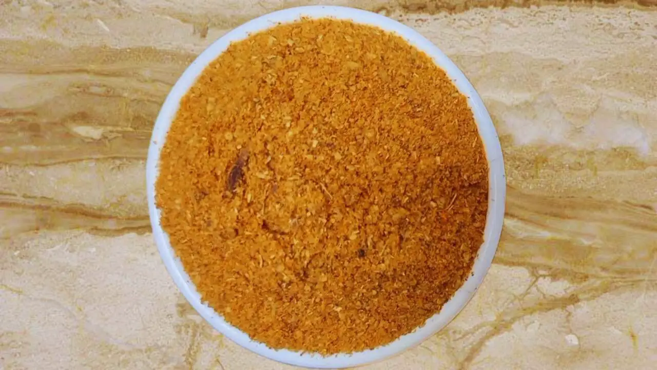 Transferring the korma masala powder into a bowl