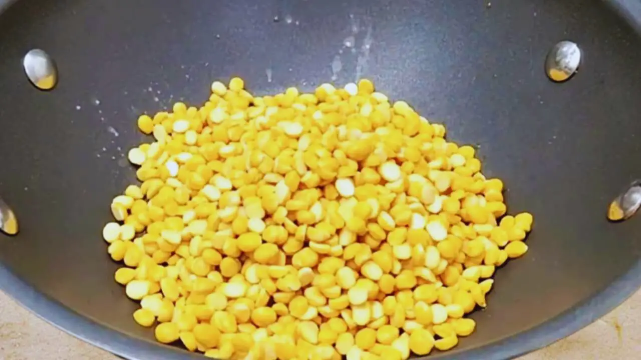 Putting 1 cup of washed split chickpea lentils in the wok