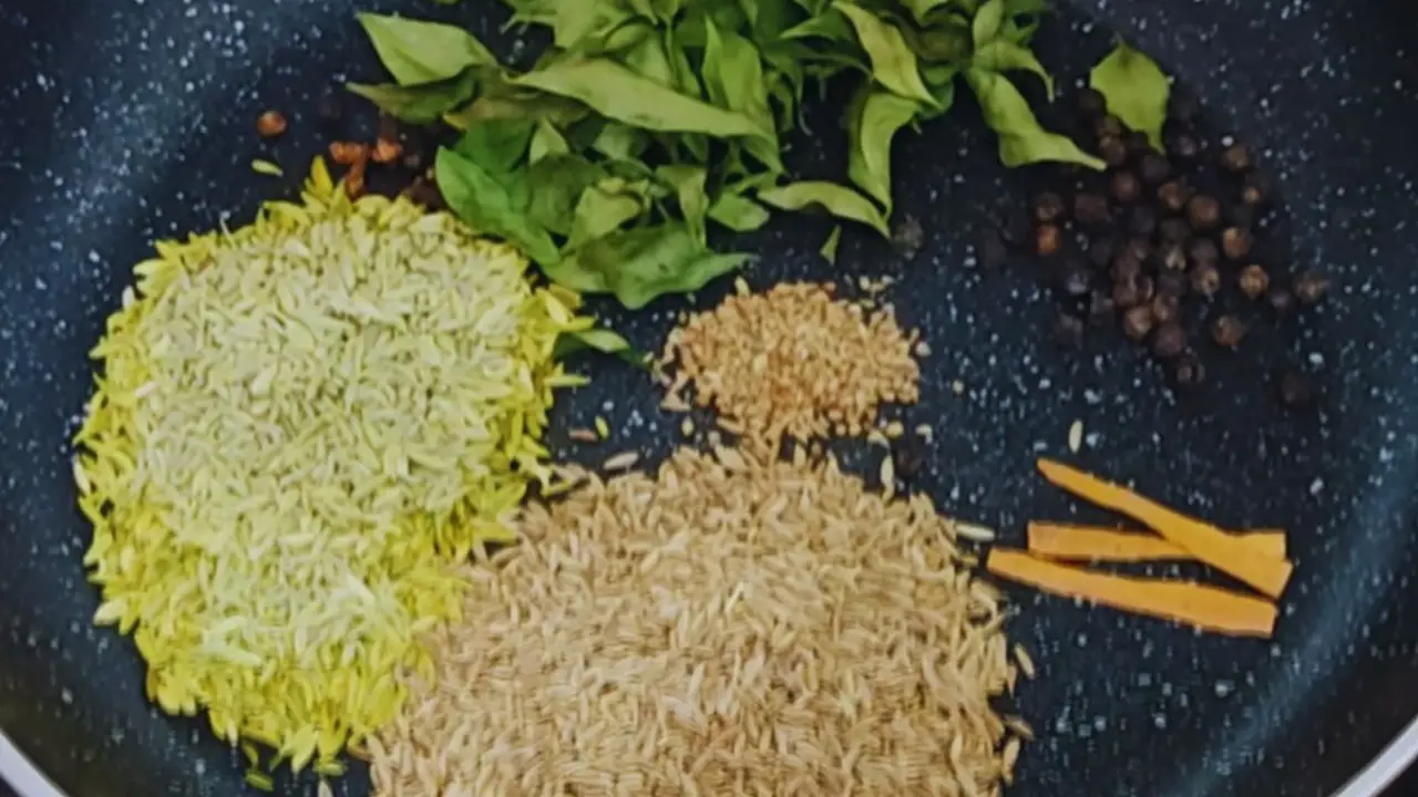 Putting 3 tbsp of cumin seeds, 3 tbsp of fennel seeds, ½ tsp cloves, ½ cup curry leaves, ½ tbsp black pepper, 3 medium-sized cinnamon sticks, and ½ tsp of carom seeds in a frying pan