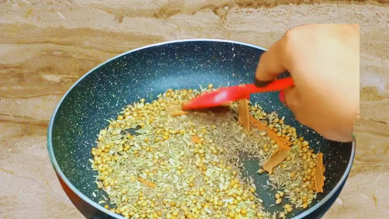 Stirring the spices continuously