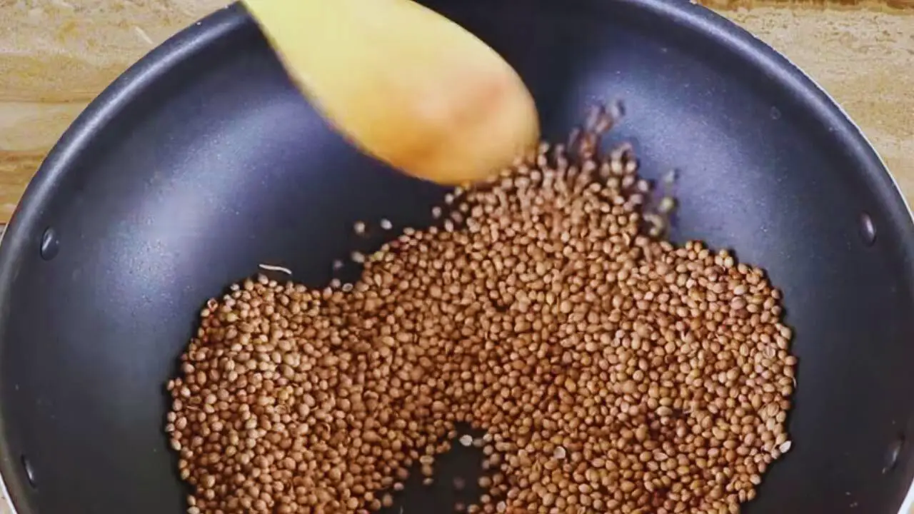 Stirring them continuously to ensure even roasting