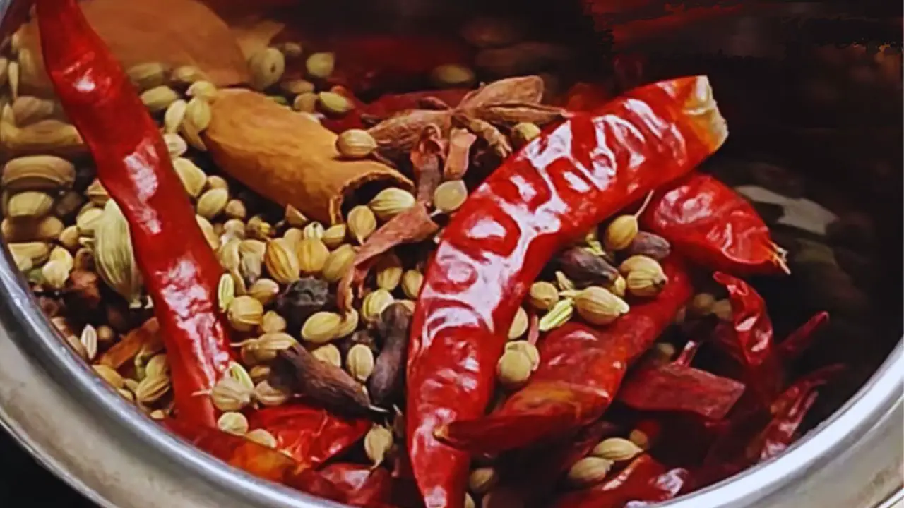 Transferring the cooled spices into a grinder
