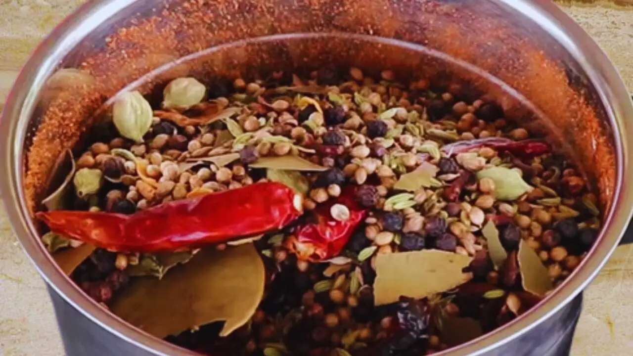 Transferring spices from the bowl to the grinder
