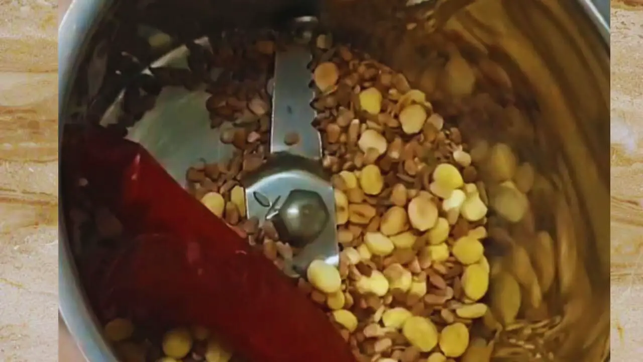 Transferring the ingredients to the grinder
