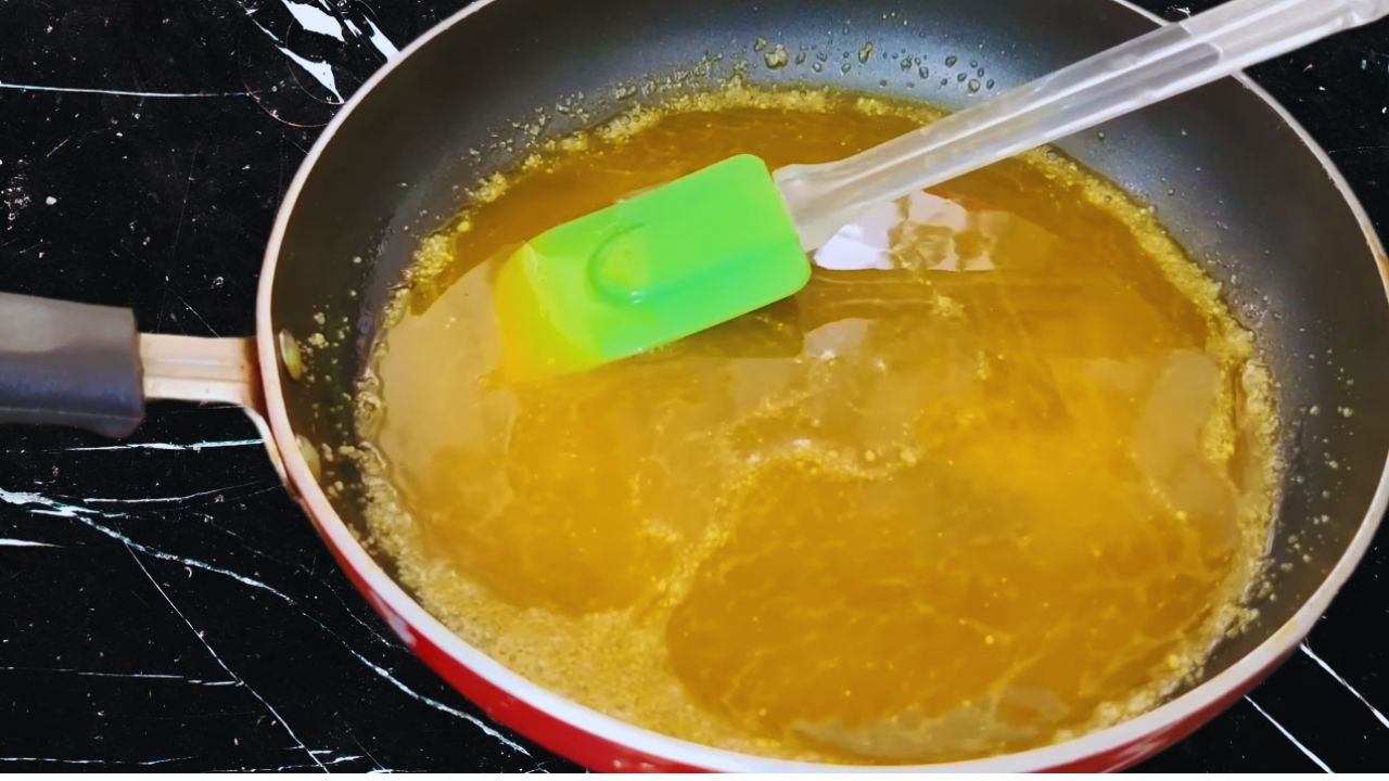 Mixing the asafoetida with a spatula