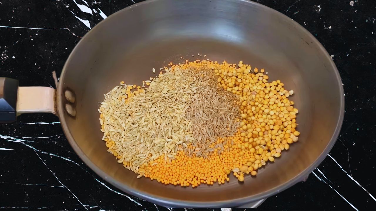 Adding 1½ tbsp coriander seeds, ½ tsp carom seeds, 3 tbsp fennel seeds, 2 tsp cumin seeds, ½ tbsp fenugreek seeds, and 1/4th cup yellow mustard seeds in a pan