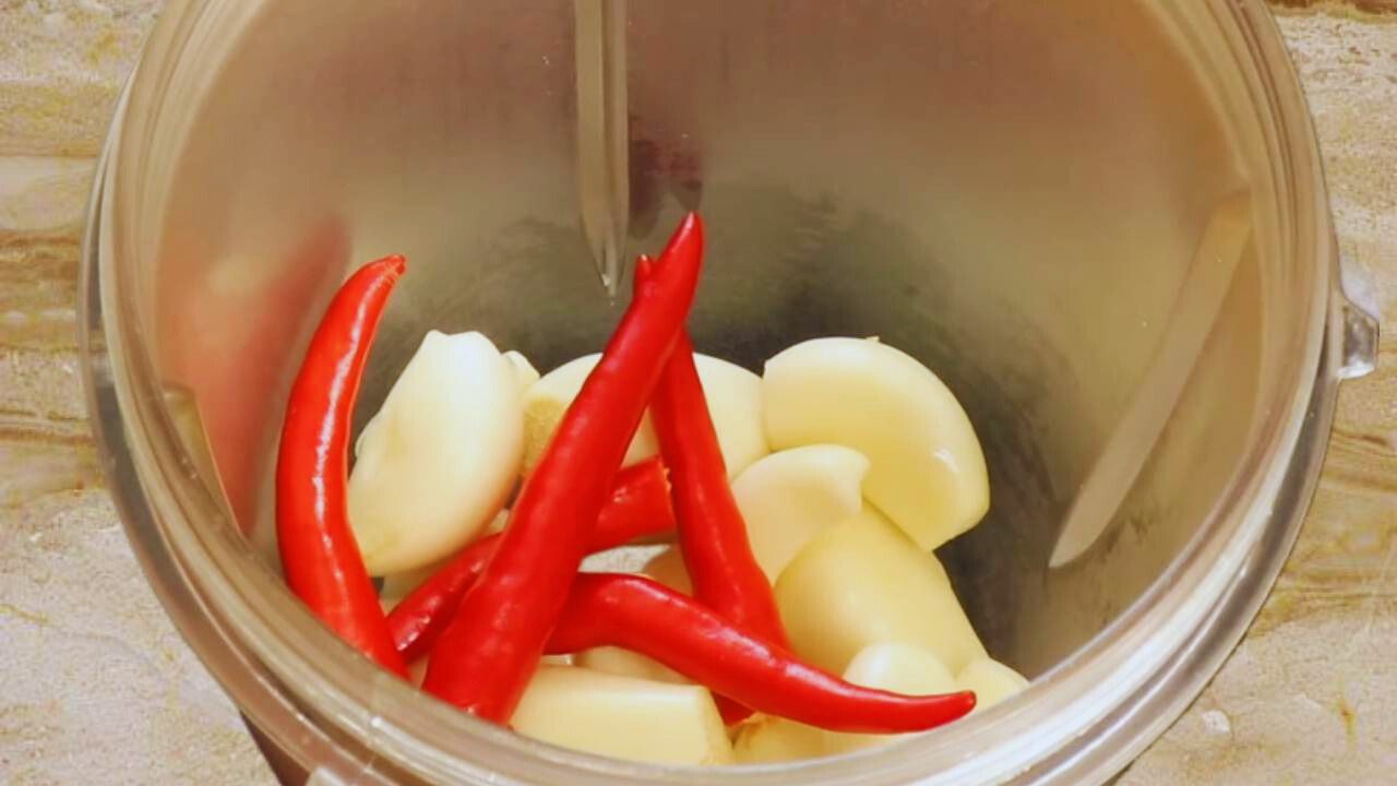 Adding 5 pieces of fresh red chilies